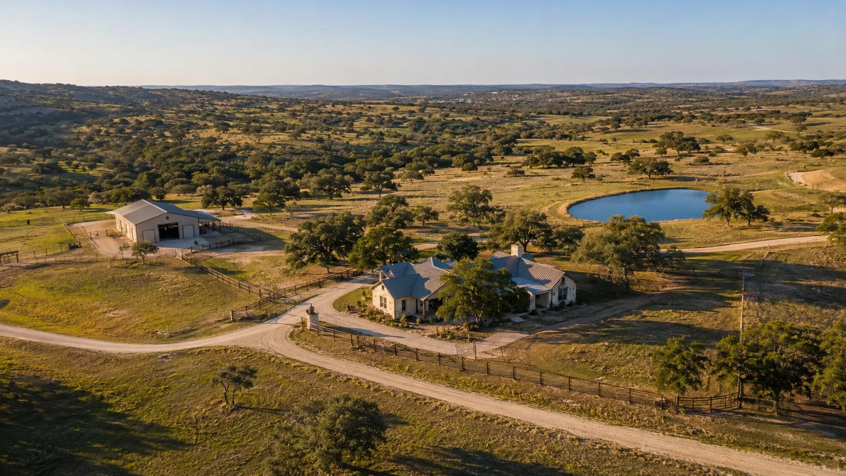 Representative aerial overview of a Texas Hill Country ranch with a residence, barn, roads, fencing and stock pond