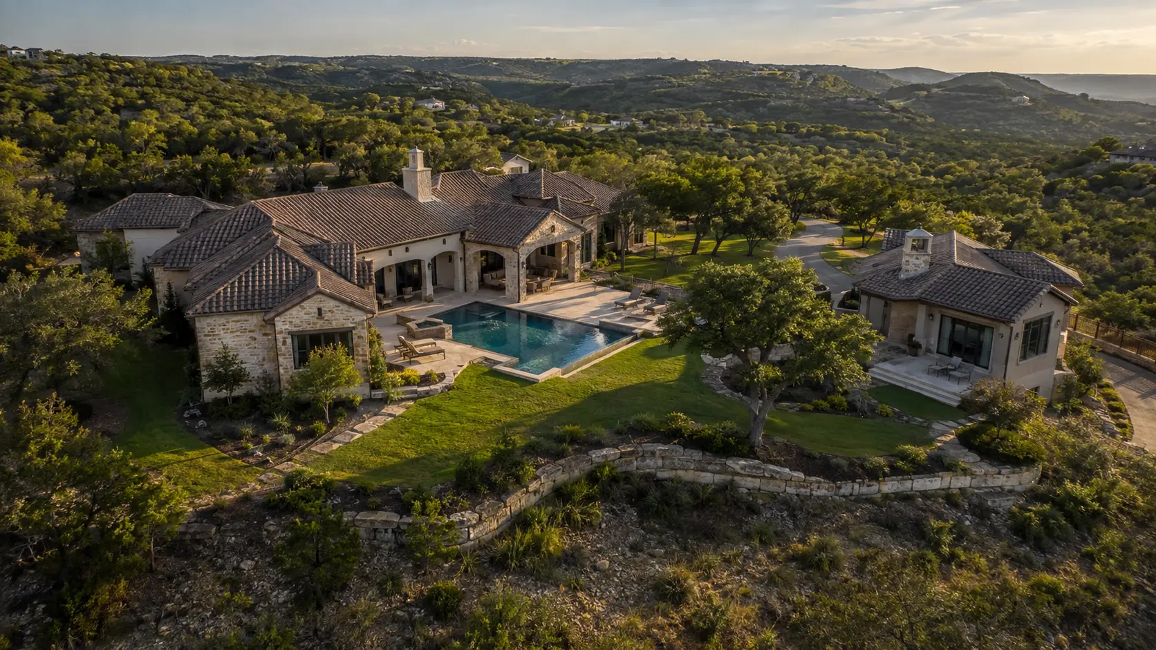 Representative aerial documentation image of a premium Hill Country residence showing the home, pool, guest structure, driveway and grounds